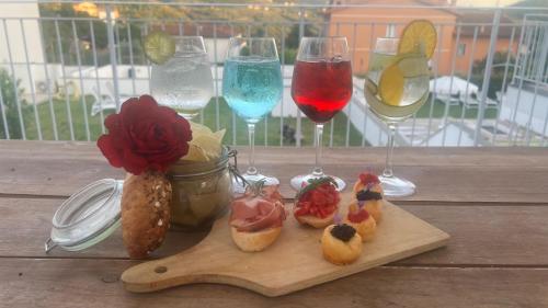 a tray of pastries and glasses of wine on a table at The Florence Hills Resort & Wellness in Pelago