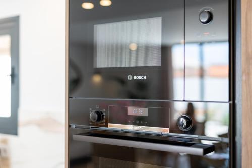a microwave oven sitting inside of a kitchen at Luxury Villa - Sunset Rooftop - Heated Pool - Outdoor Kitchen - Airconditioned in Palm-Mar