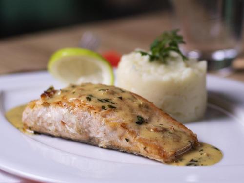 a white plate with a piece of fish and mashed potatoes at Ibis Casablanca City Center in Casablanca
