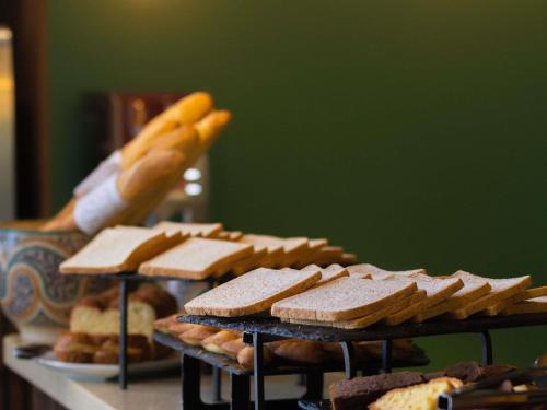 a table topped with different types of cookies and bread at Ibis Casablanca City Center in Casablanca