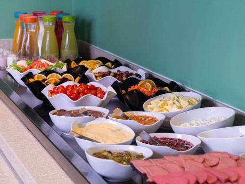 a buffet with many different types of food in bowls at Ibis Casablanca City Center in Casablanca