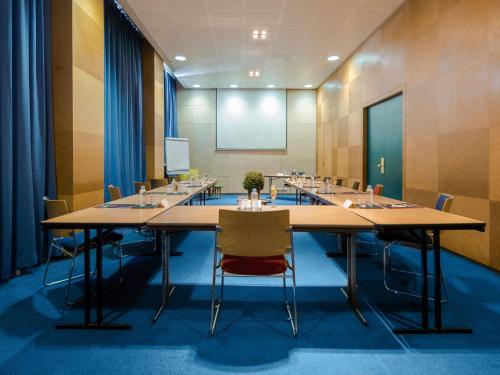 a conference room with a large table and chairs at Ibis Casablanca City Center in Casablanca