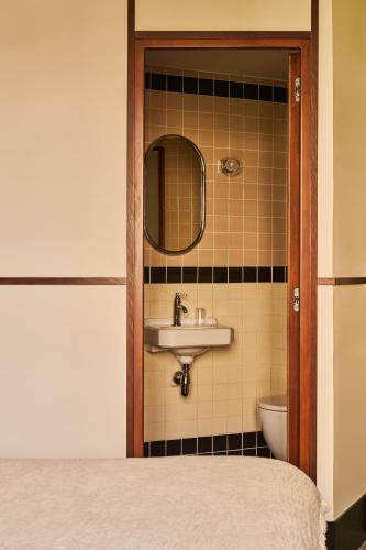 a bathroom with a sink and a toilet at Hôtel Marguerite in Paris
