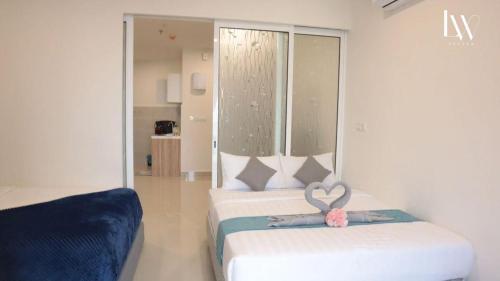 a bedroom with a bed with a large window at The Shore Kota Kinabalu City Centre by LW Suites in Kota Kinabalu