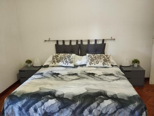 a bedroom with a large bed with two night stands at LA LANTERNA DI ANGELO rent rooms and apartments free parking on the street front in Genova