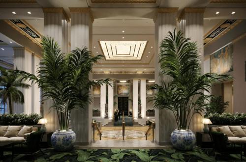 a lobby with two palm trees in vases at Waldorf Astoria New York in New York