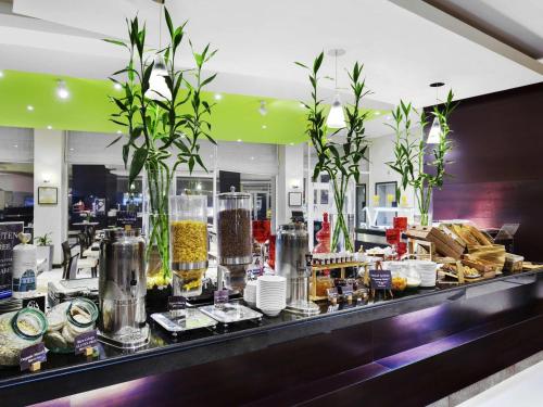 a buffet line with food on display in a restaurant at ibis Muscat in Muscat