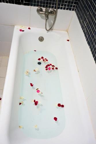 a bath tub filled with flowers in a bathroom at Hotel Nouzha in Fès
