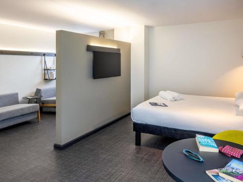 Una habitación de hotel con una cama y un televisor. en ibis Bristol Temple Meads, en Bristol