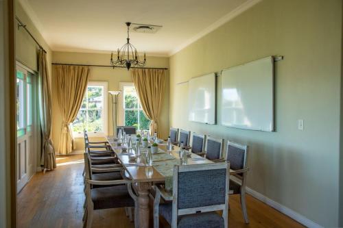 a long dining room with a long table and chairs at Zevenwacht Country Inn in Kuilsrivier
