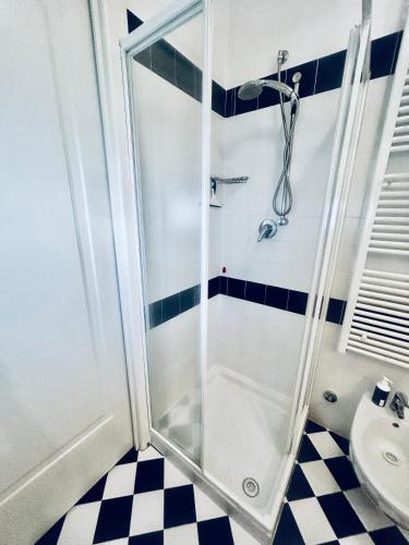 a shower stall in a bathroom with a checkered floor at Mono Ele a Varigotti in Varigotti