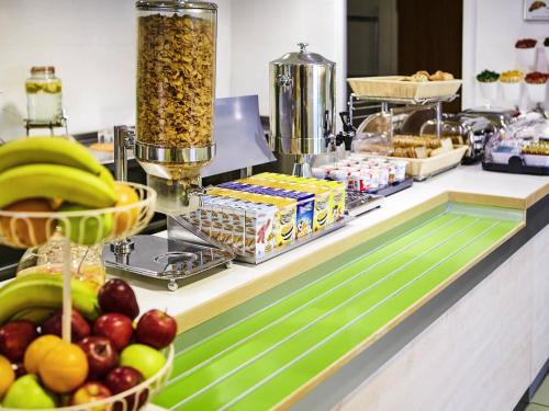 a buffet with fruit and other food on a counter at ibis budget Leicester in Leicester