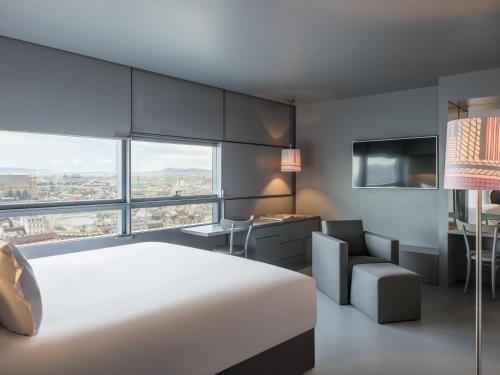 a bedroom with a bed and a desk and a chair at SO/ Vienna in Vienna