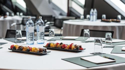 a table with two plates of food and bottles of water at SO/ Vienna in Vienna