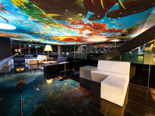 a lobby with a ceiling with a painting of butterflies at SO/ Vienna in Vienna