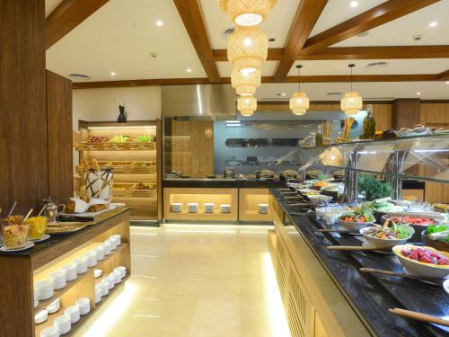 a large kitchen with a buffet line with food at Novotel Cairo El Borg in Cairo