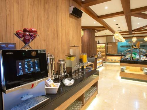 a kitchen with a counter with aasteryasteryasteryasteryasteryasteryasteryasteryastery at Novotel Cairo El Borg in Cairo