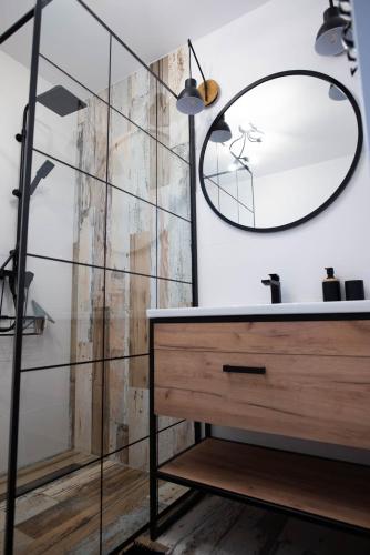a bathroom with a mirror and a sink at MarinaMar Karwia in Sławoszynko