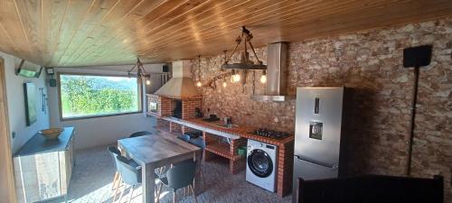 a kitchen with a counter and a refrigerator in a room at Casa da Moda - Turismo de Campo in Vieira do Minho