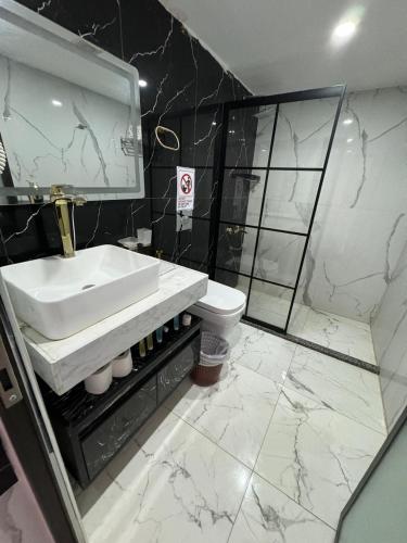 a bathroom with a sink and a shower and a toilet at Mira Bubble Luxury Camp in Wadi Rum