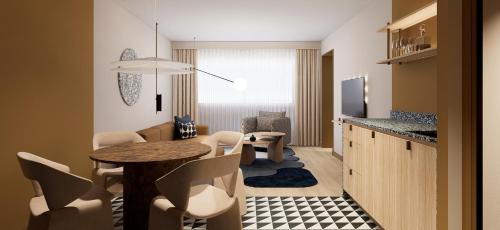 a small living room with a table and chairs at Mercure Hotel Den Haag Central in The Hague