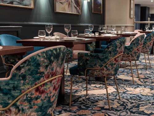 a dining room with tables and chairs with wine glasses at Mercure Blackburn Dunkenhalgh Hotel & Spa in Blackburn
