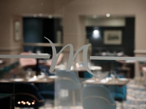a close up of a metal sign in a restaurant at Mercure Blackburn Dunkenhalgh Hotel & Spa in Blackburn