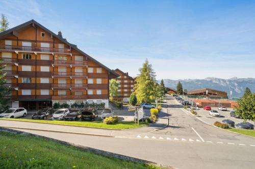 a view of a hotel with a parking lot at Central studio in Villars sur Ollon, Emeraude, for 3 only 100m to Bretaye ski train in Villars-sur-Ollon
