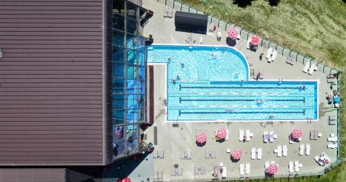 an overhead view of a swimming pool with tables and chairs at Shackleton Chalet in Sestriere