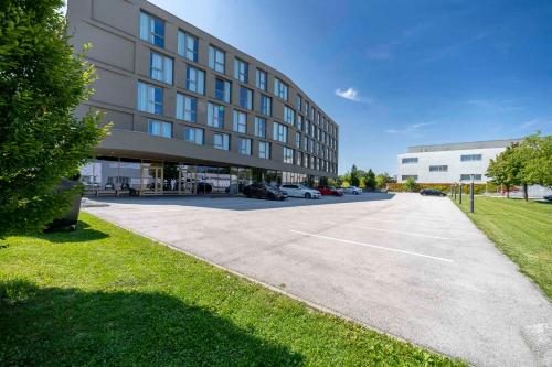 a large building with a parking lot in front of it at ibis Wels in Wels