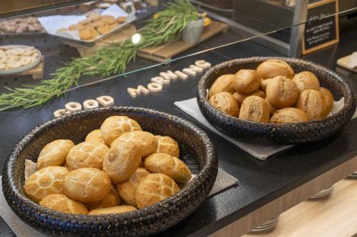 two baskets of bread on a counter in a bakery at ibis Wels in Wels