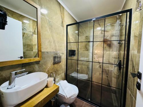 a bathroom with a sink and a shower at Treekos Suite Hotel Istanbul Airport in Arnavutköy
