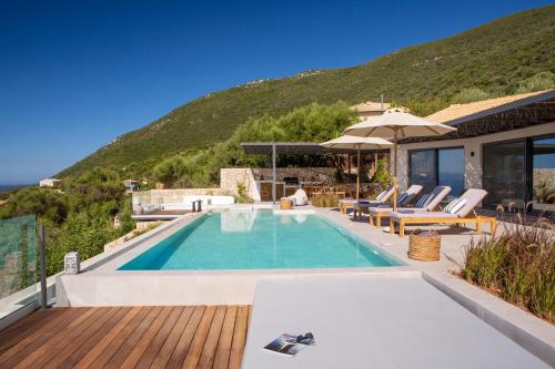 a villa with a swimming pool and a house at Cloud Nine Villa in Évyiros