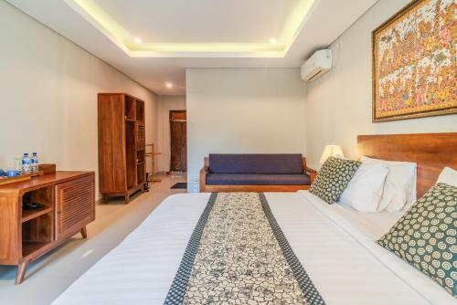 a hotel room with a bed and a desk at The Kertha Ubud in Ubud