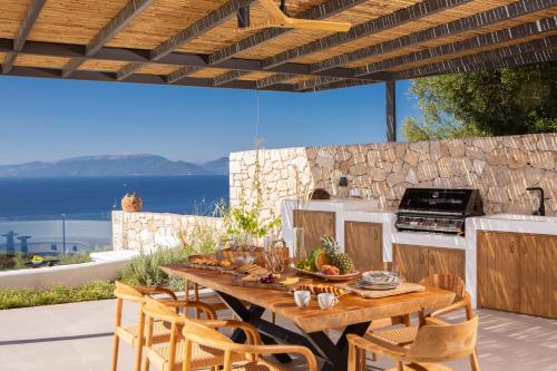 a table and chairs on a patio with a kitchen at Cloud Nine Villa in Évyiros