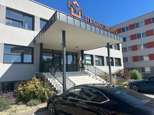 a black car parked in front of a building at 111Apartments in Košice