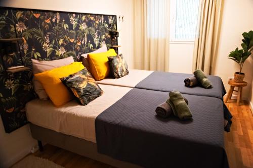 a bedroom with a large bed with yellow pillows at El Toro Apartments in Altea