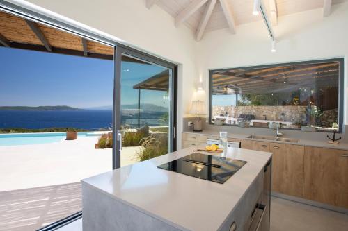 a kitchen with a view of the ocean at Cloud Nine Villa in Évyiros
