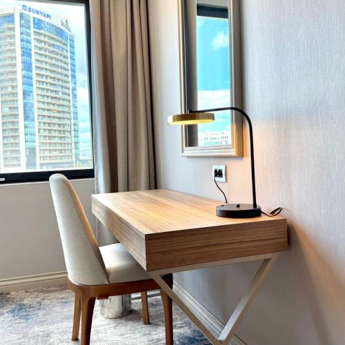 a desk with a lamp and a chair next to a window at Sia Hotel Thermal & Spa in Nilüfer