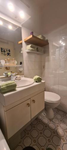a bathroom with a sink and a toilet and a mirror at Incroyable Vue mer et Notre Dame in Marseille