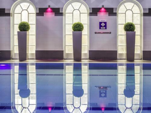 a pool of water with plants in front of a building at Mercure Exeter Southgate Hotel in Exeter