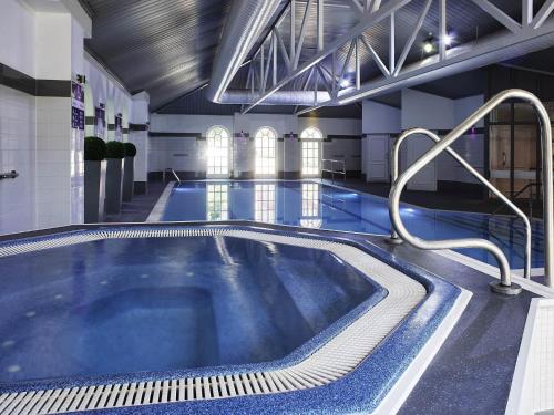 a large swimming pool in a building at Mercure Exeter Southgate Hotel in Exeter
