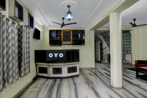 a living room with a ovo sign on a table at Home of Backpackers in Jaipur