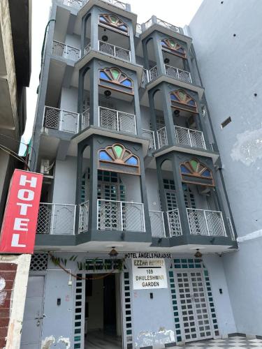 a tall building with balconies on the side of it at Home of Backpackers in Jaipur