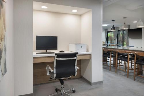 an office with a desk with a computer and a chair at Fairfield by Marriott Mission Viejo Orange County in Mission Viejo