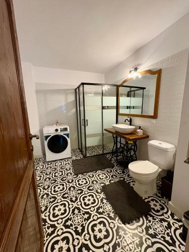 a bathroom with a toilet and a sink in it at Luna House Busteni in Buşteni