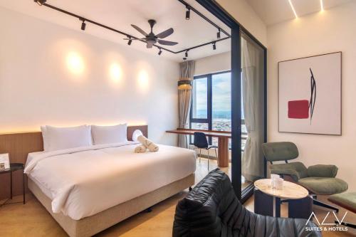 a hotel room with a bed and a chair at 22 Macalisterz by ALV in George Town