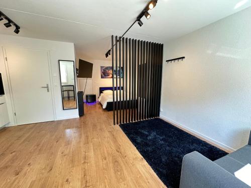 a living room with a couch and a bed at Cosy private room in Lausanne center in Lausanne