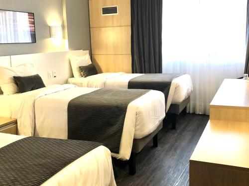 Ein Bett oder Betten in einem Zimmer der Unterkunft Mercure Camboriu