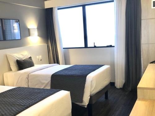 Ein Bett oder Betten in einem Zimmer der Unterkunft Mercure Camboriu